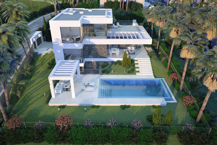 an aerial view of a house with a swimming pool in the foreground and palm trees surrounding it