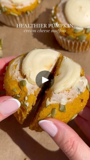 a hand holding a half eaten pumpkin cupcake