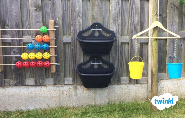 there are several plastic toys hanging on the fence