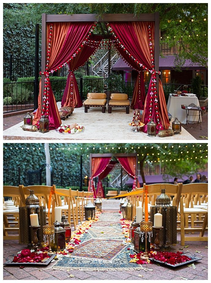 the wedding ceremony is decorated with red drapes and candles