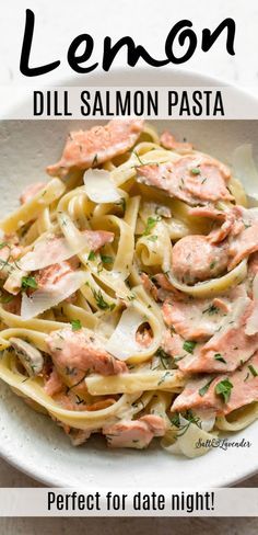 a white bowl filled with pasta covered in salmon sauce