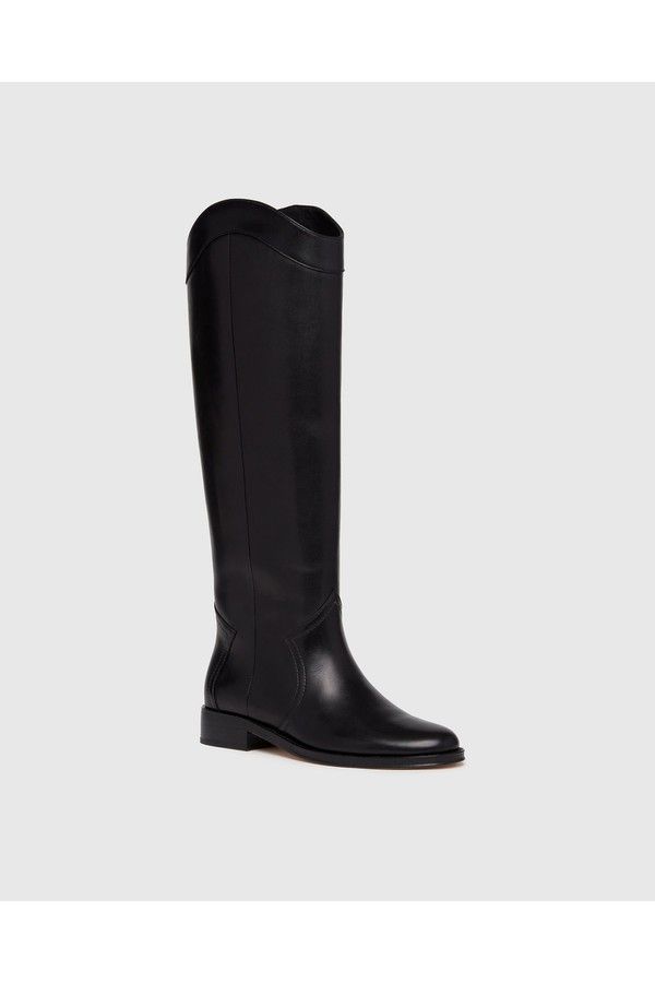 Find PAIGE Raina Boot on Editorialist. Raina is our take on the classic riding boot. Crafted from a super durable yet luxuriously soft black leather, this timeless straight shaft tall boot is designed with a curved topline that dips at the front and back for a flattering look, western-inspired pattern and stitch detailing, an extended leather welt with tonal stitch details, and a black leather stacked 20mm heel for a slight amount of lift. The classic menswear-inspired details on the outsole inc Classic Calf Leather Knee-high Boots For Business, Classic Knee-high Boots For Business, Classic Wide Calf Knee-high Boots In Calf Leather, Classic Calf Leather Knee-high Boots With Leather Sole, Classic Knee-high Boots In Calf Leather, Classic Calf Leather Wide Calf Knee-high Boots, Classic Knee-high Boots With Calf Leather, Elegant Wide Calf Knee-high Riding Boots, Elegant Wide Calf Knee-high Boots For Riding