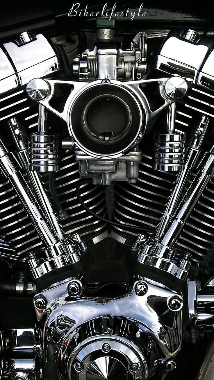 the front end of a motorcycle with chrome and black paint on it's engine