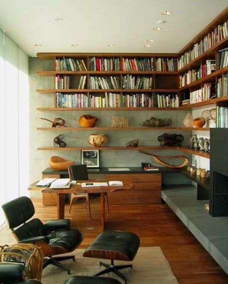 a living room filled with furniture and bookshelves