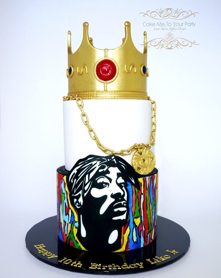 a cake with a crown on top of it and a chain around the neck that is attached