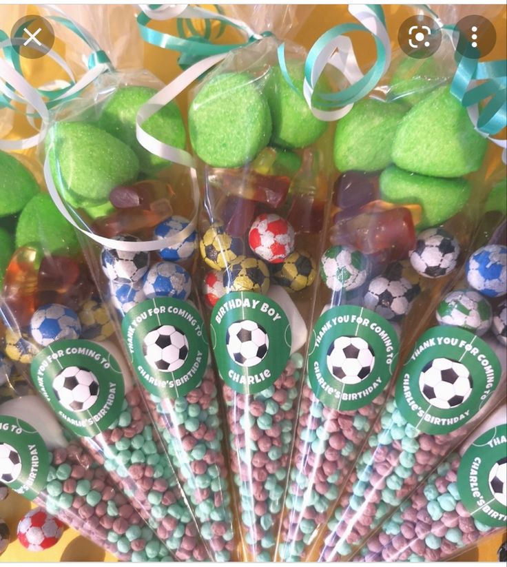 there are many candy sticks with soccer balls on them