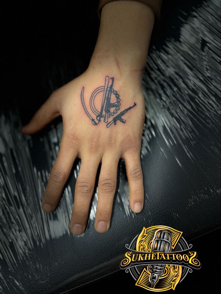 a person's hand with a tattoo on it and a knife in the middle