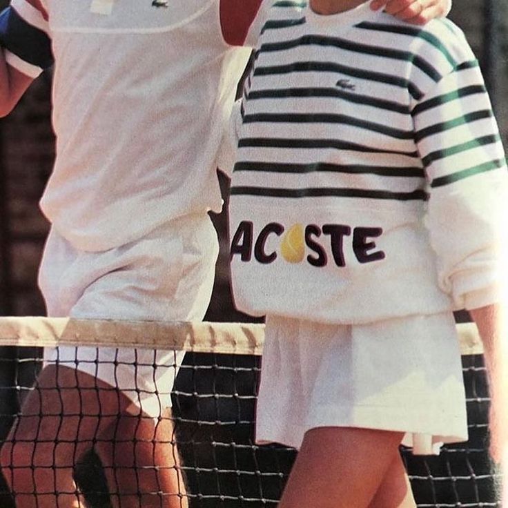 two tennis players hugging each other on the court