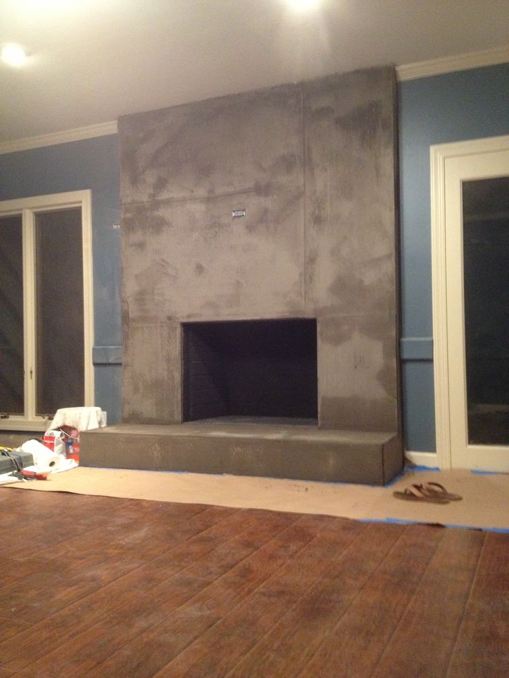 a living room that is being remodeled with blue walls and wood flooring in the foreground