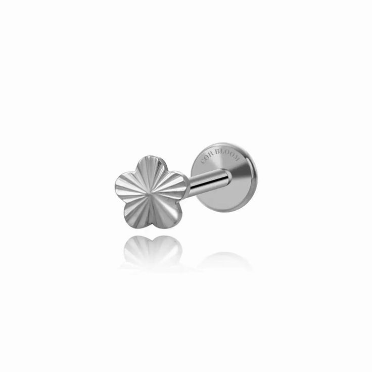 a pair of stainless steel flower earrings on a white background with reflection in the foreground