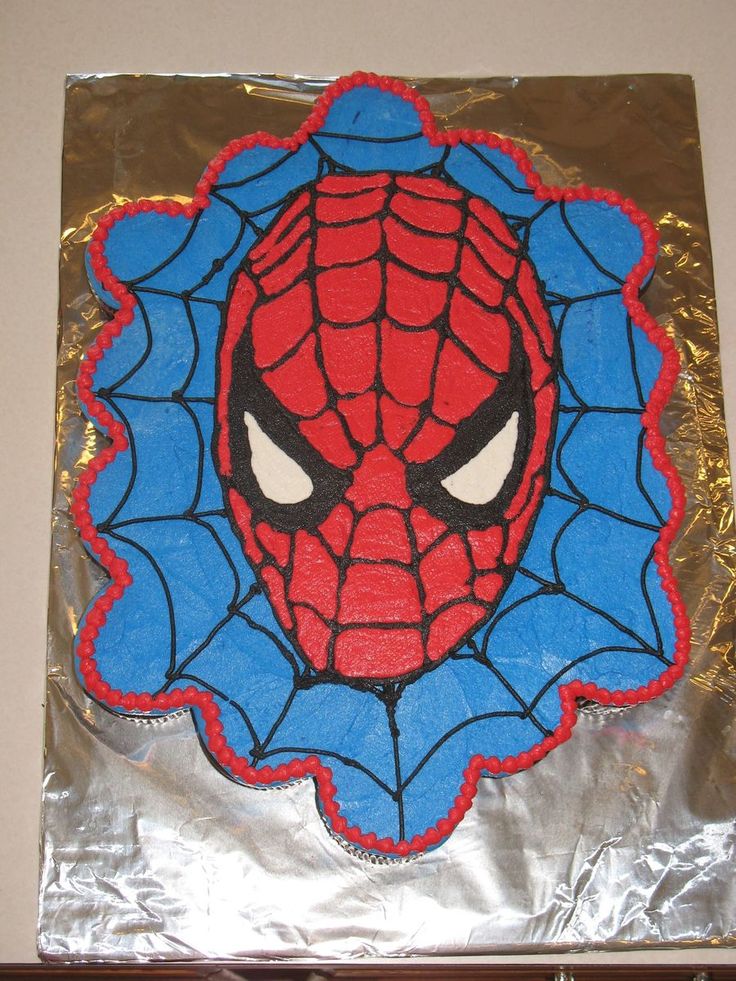 a spiderman cake on top of aluminum foil