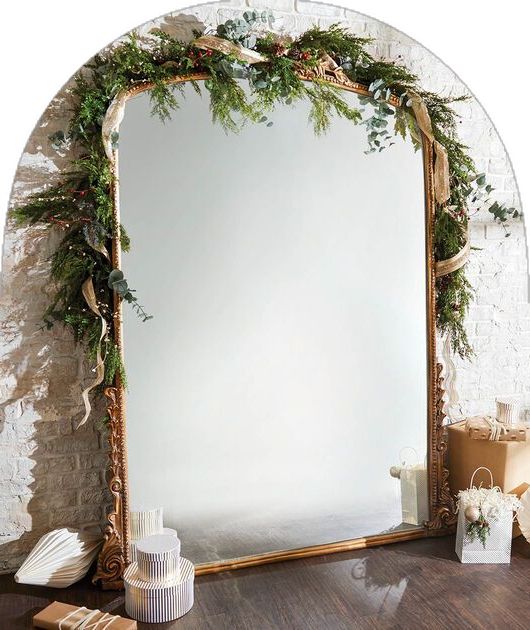 a large mirror sitting on top of a wooden table