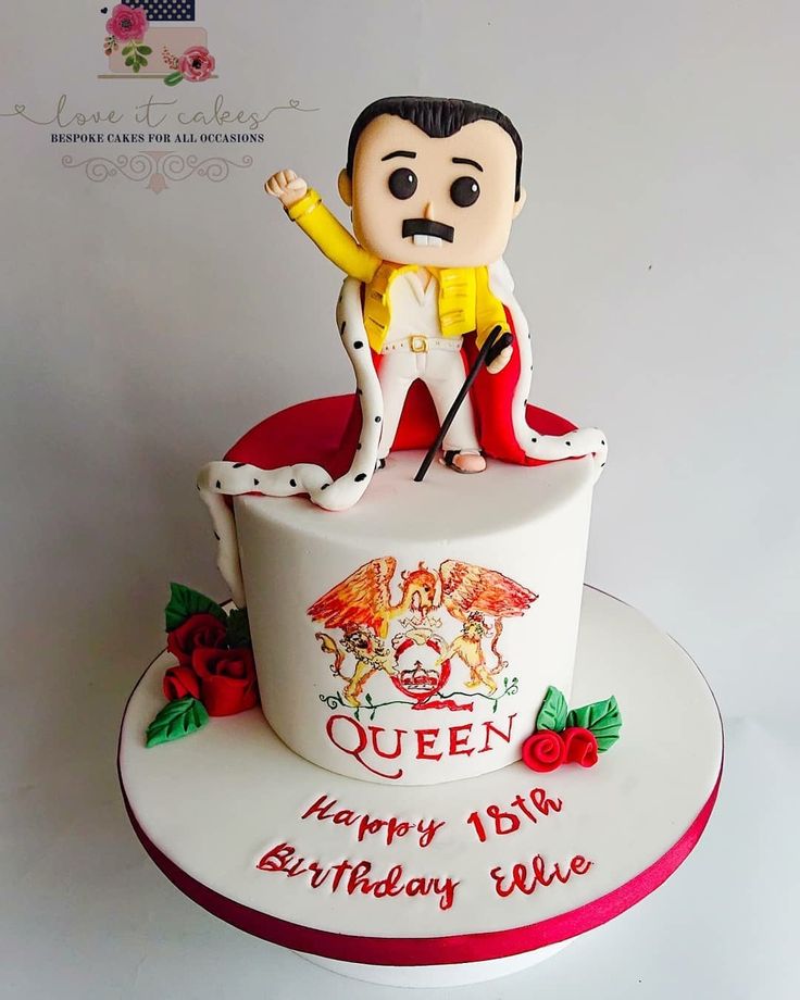 a birthday cake with an image of a man on top and the words queen written in red