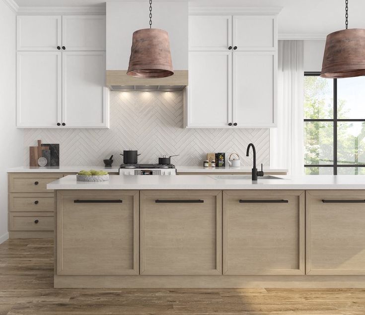 a kitchen with white cabinets and wooden floors, two pendant lights over the island counter