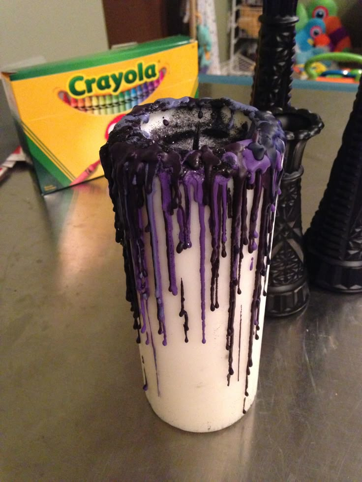 four different shots of halloween candles with purple and orange icing on them, one in a glass vase the other in a plastic cup