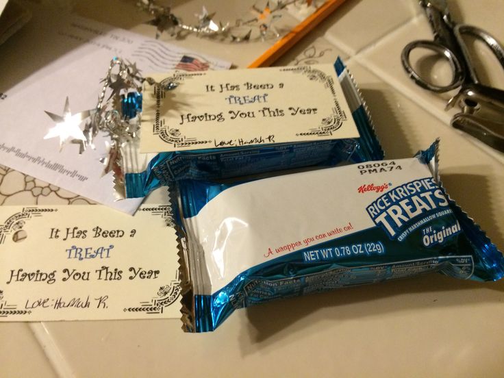 two candy bars sitting on top of a counter next to scissors