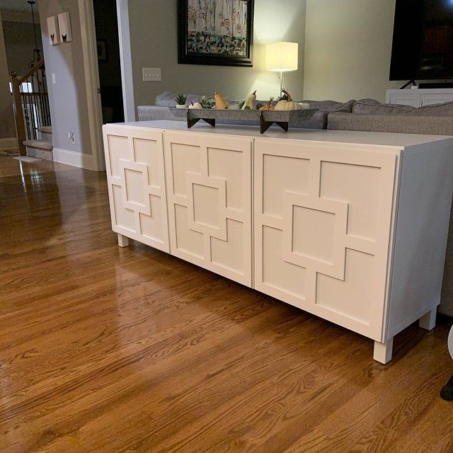 a living room with hard wood floors and white furniture