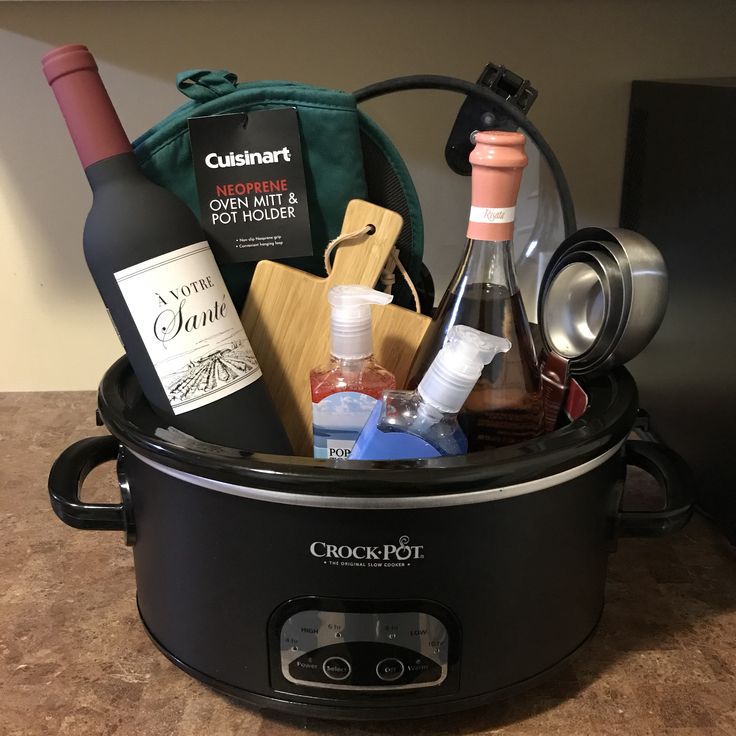 a crock pot filled with wine bottles and other condiments