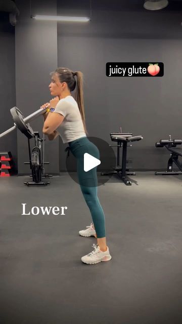 a woman doing squats with a barbell in a gym room, and the caption reads lower glute