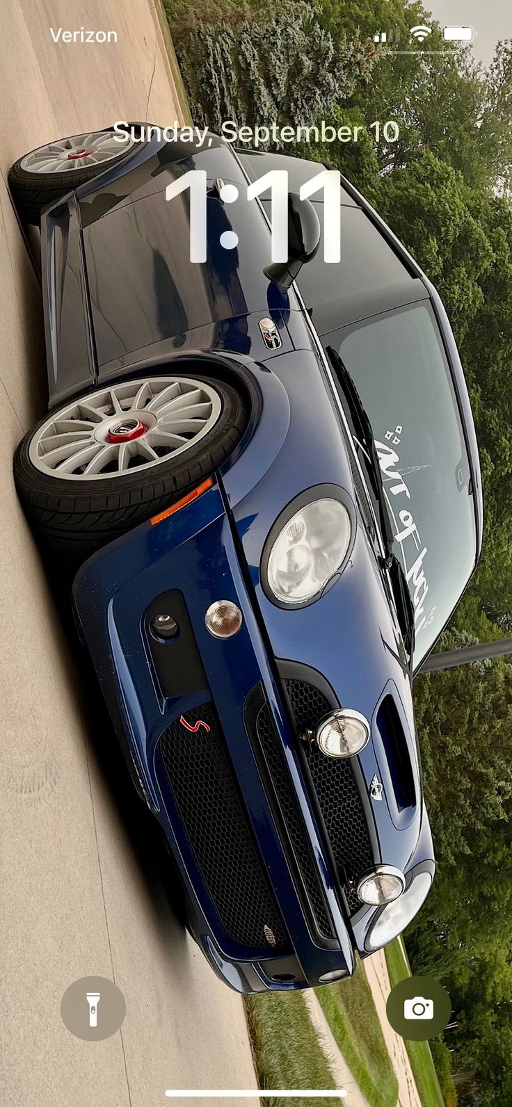 the front end of a blue sports car