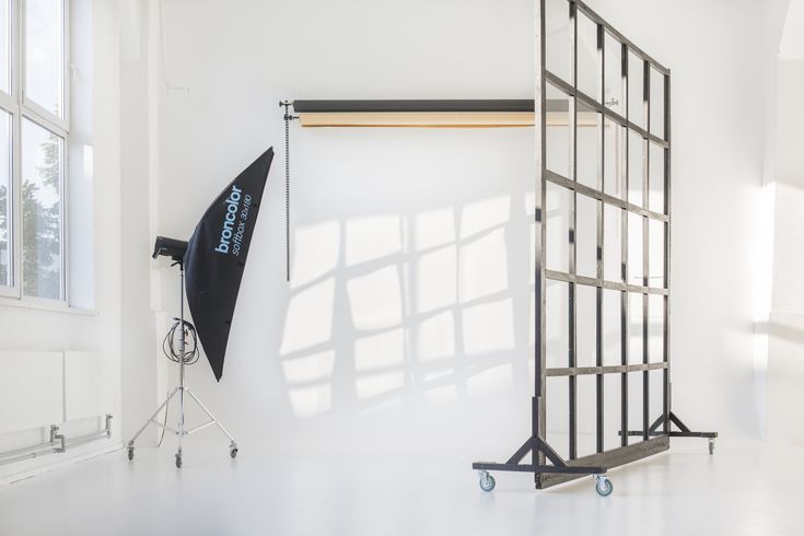 an empty room with two photography equipment on the floor