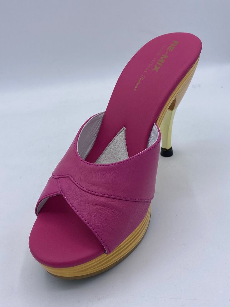 This iconic 1950's style stiletto slide is comfortable and sexy with a padded foot-bed and stable base. Leather uppers with blond wood platform sole Whole sizes, 5-11 4½" metallic finished stiletto heel with a ⅞" laminated wood platform Imported Pink Mules With 4-inch Heel And Open Heel, Pink Mules With 4-inch Open Heel, Modern Slip-on Heels With Wooden Heel, Modern Pink High Heel Mules, Fitted High Heel Mules With Deep Heel Cup, Pink Open Toe Mules With 4-inch Heel, Pink High Heel Platform Mules, Pink Slip-on Heels With Sculpted Heel, Modern Pink Sandals With Deep Heel Cup