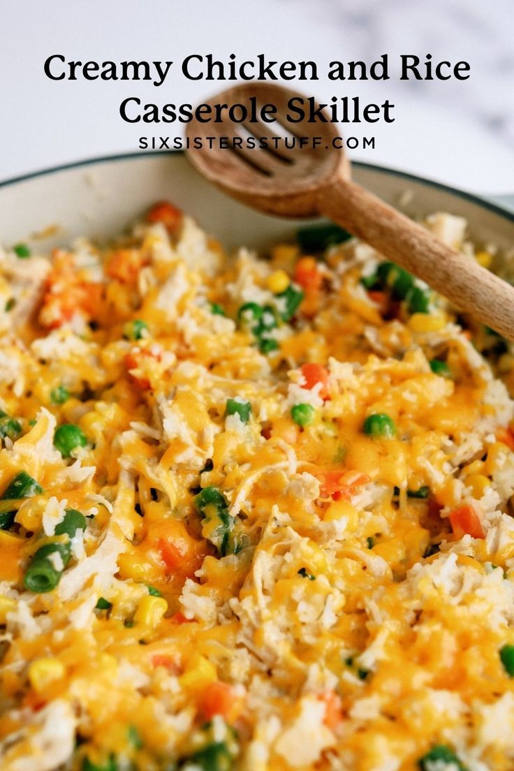 creamy chicken and rice casserole skillet in a pan with a wooden spoon