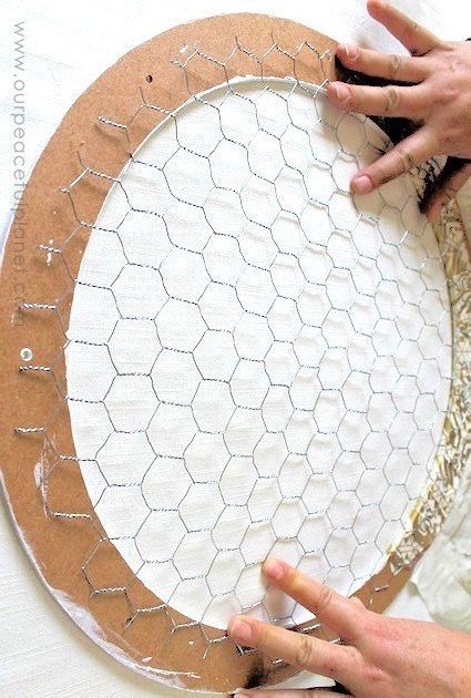 a woman is making a paper plate with chicken wire on it and another person's hands