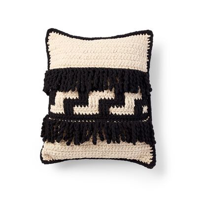 a black and white crocheted pillow on a white background with the letter e