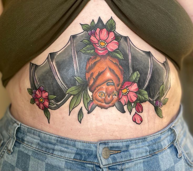 a woman's stomach with an image of a cat and flowers on it