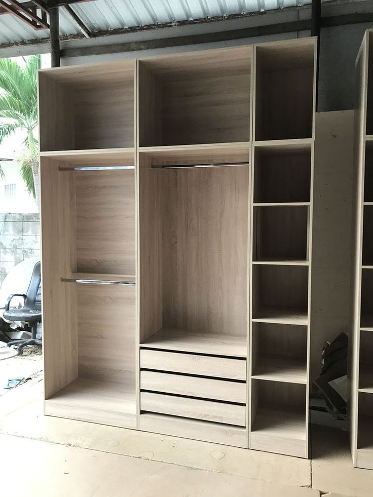 an empty closet with several shelves and shoes on the floor in front of a car