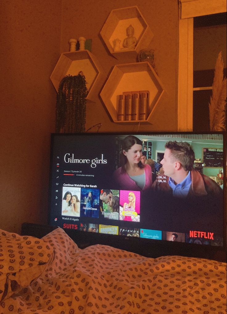 a flat screen tv sitting on top of a bed