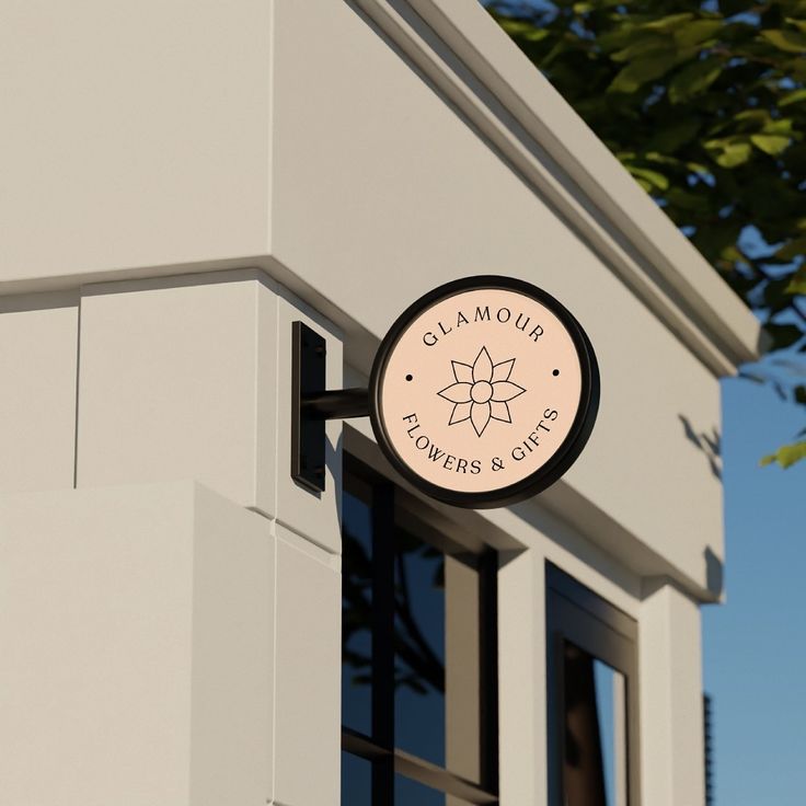 a close up of a sign on the side of a building with trees in the background