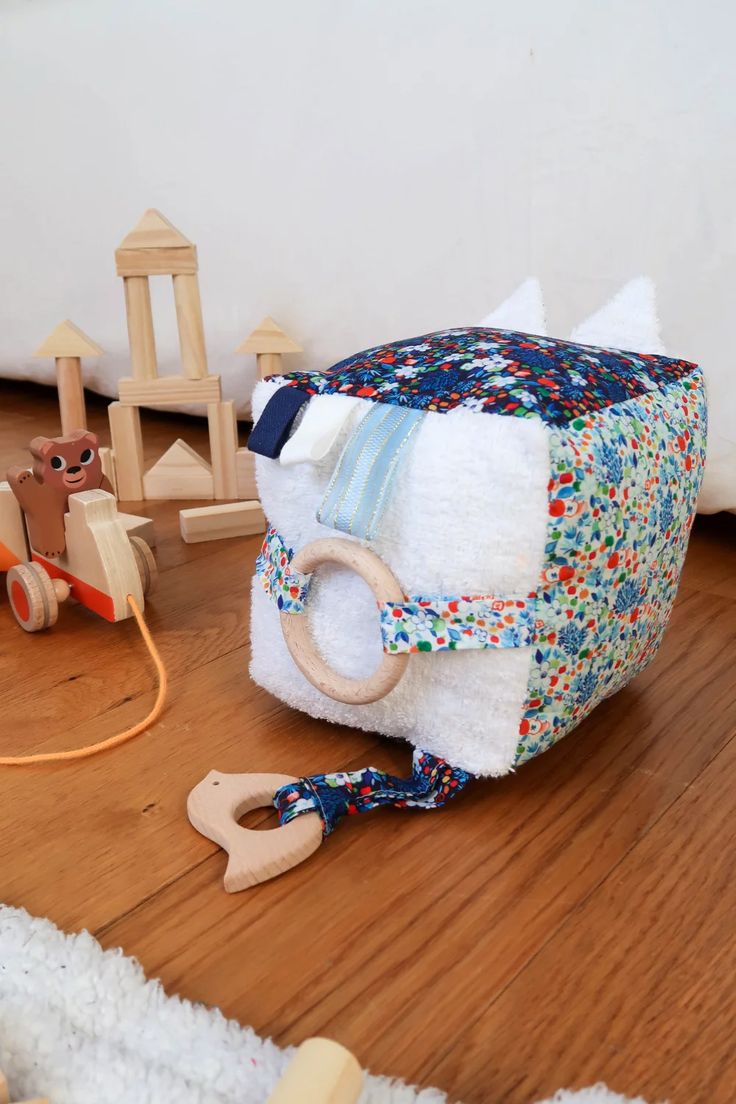 a baby's toy is laying on the floor next to its play house and toys