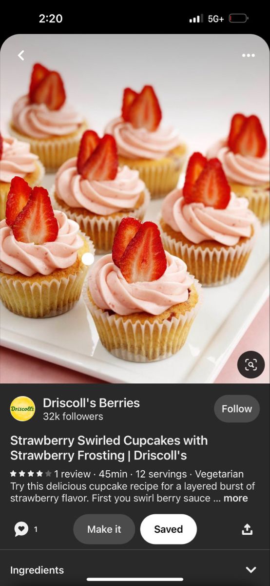 a plate with cupcakes topped with strawberry frosting and strawberries on top