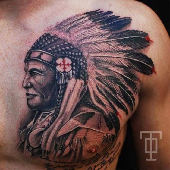 a man with a native american headdress on his chest