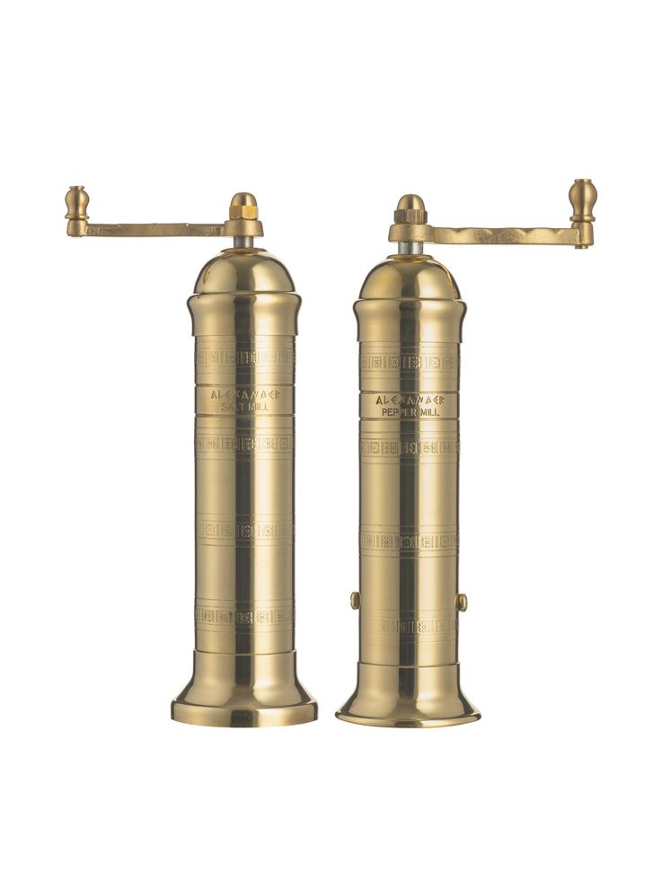 two brass - plated pepper grinds are shown against a white background