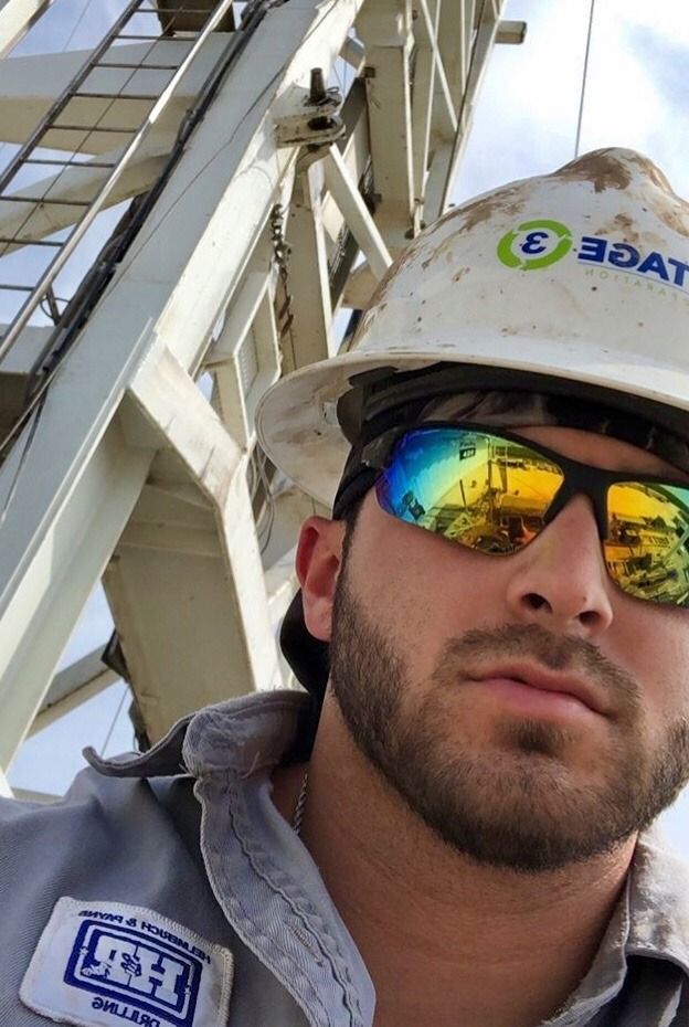 a man wearing sunglasses and a hard hat