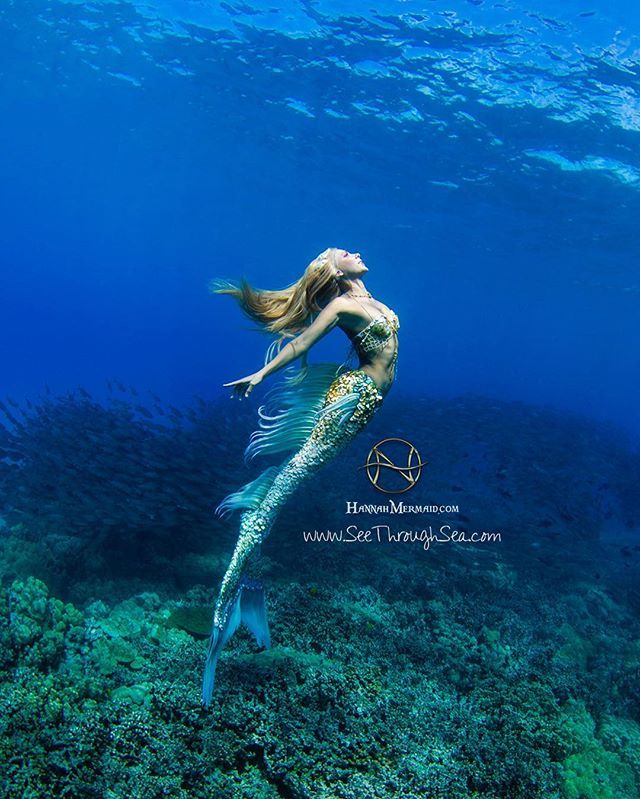 a woman is swimming in the ocean with her long hair blowing back over her head