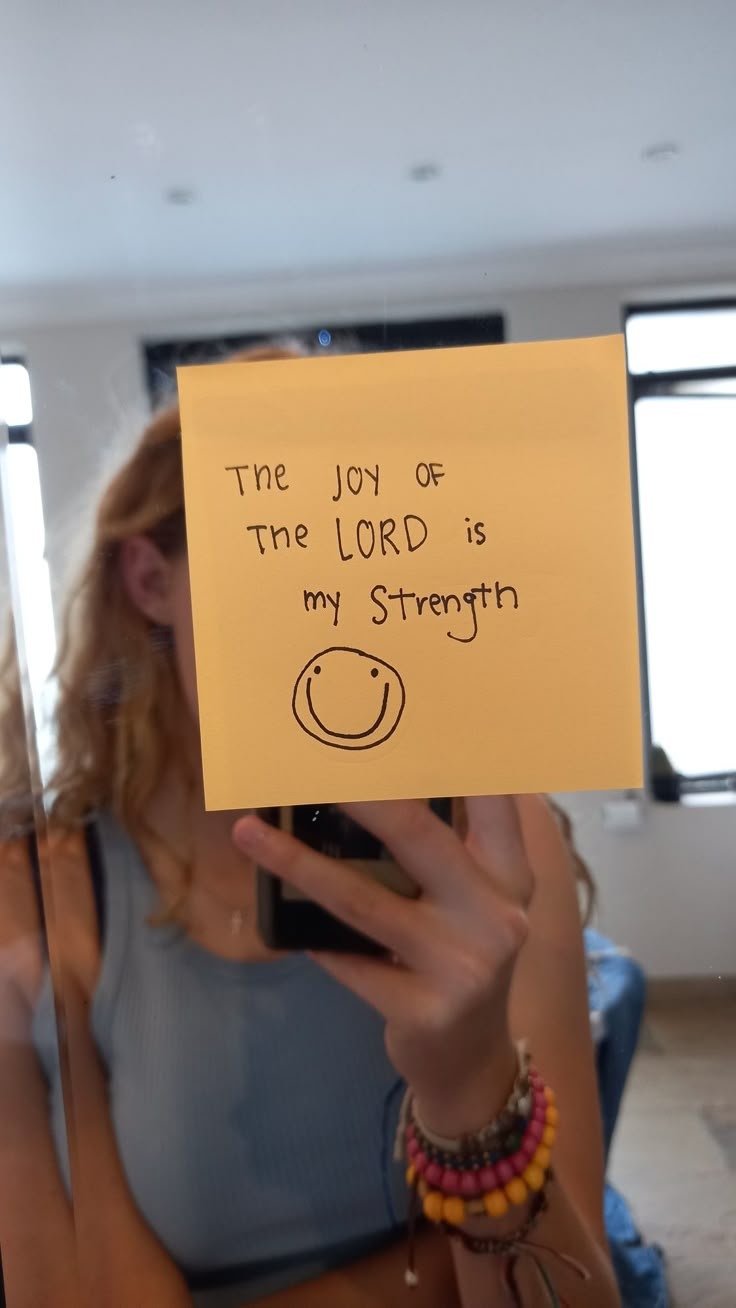 a woman holding up a note that says the joy of the lord is my strength