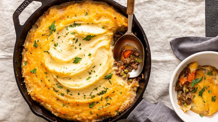 a skillet filled with mashed potatoes and meat