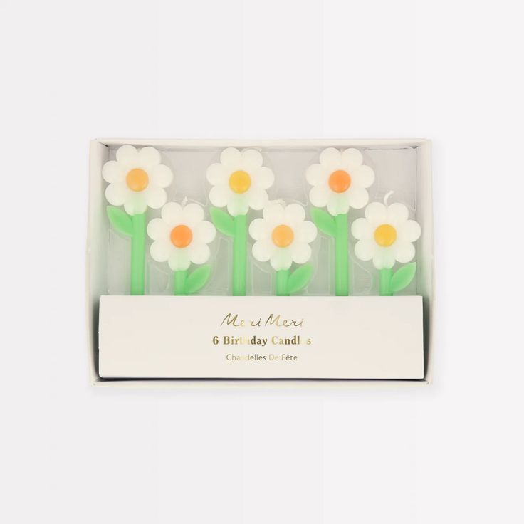 four small white and orange flowers in a box with the words mr & mrs on it