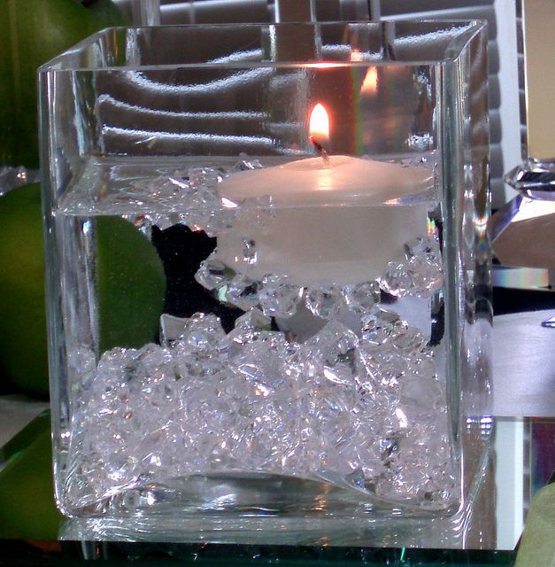 an ice cube with a lit candle in it