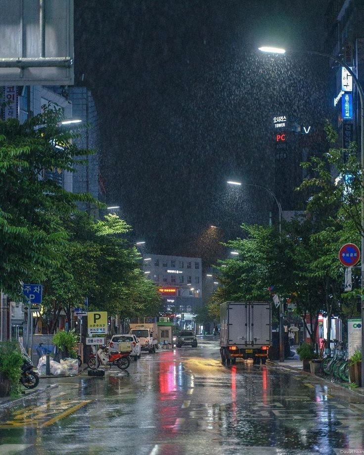 a city street at night in the rain