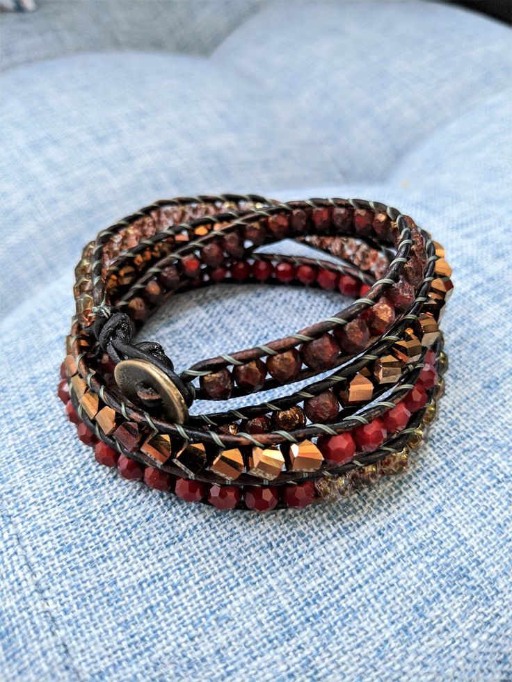 Handcrafted quadruple leather wrap bracelet, made with czech glass and semiprecious stone beads. Approximate wrist width of 6.5"; see photos for sizing. Wrap Bracelet With Faceted Beads For Festivals, Faceted Beads Wrap Bracelet For Festivals, Wrap Bracelet With Faceted Round Beads For Festival, Adjustable Jewelry With Faceted Beads For Fashion Accessory, Adjustable Jewelry With Faceted Beads For Fashion, Adjustable Multi-strand Wire Wrapped Beaded Bracelets, Elegant Adjustable Wrap Bracelet With Natural Stones, Multi-strand Faceted Beads Wrap Bracelet For Jewelry Making, Adjustable Brown Crystal Bracelet With Faceted Beads