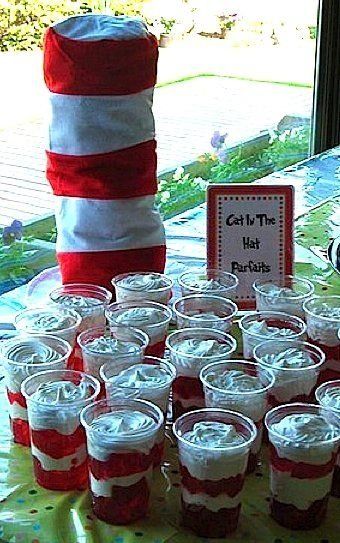 there are many cups on the table and one has a cat in the hat sign