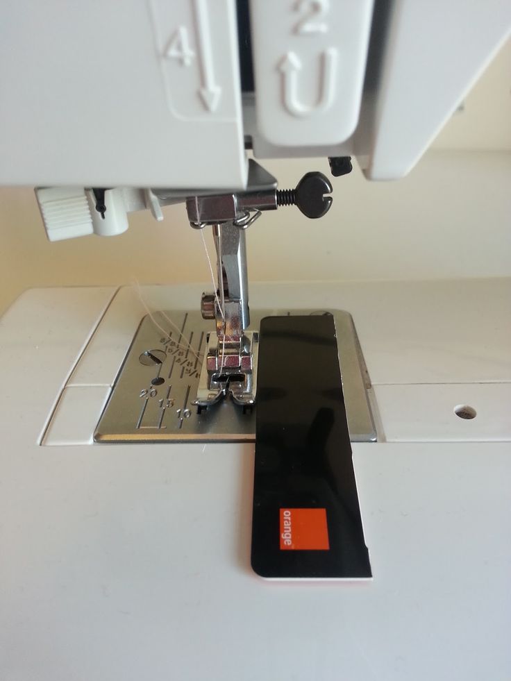 the sewing machine has an orange tag on it