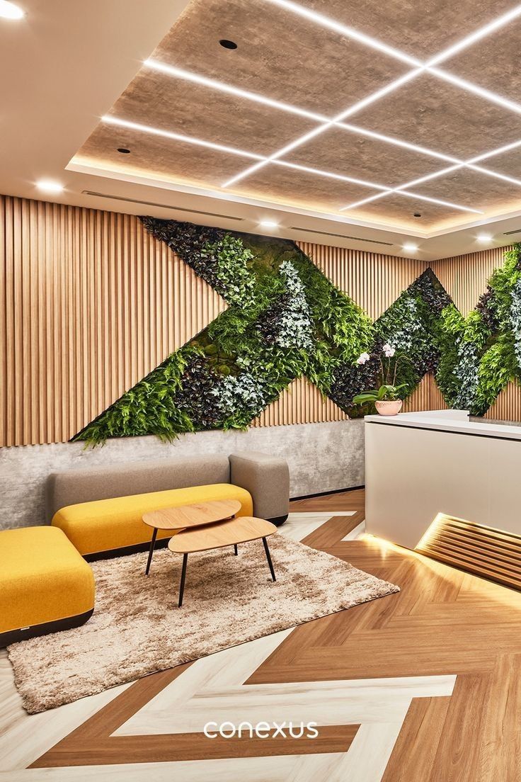 an office lobby decorated with green plants and modern furniture