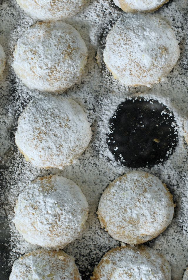 powdered sugar covered pastries sitting on top of a table