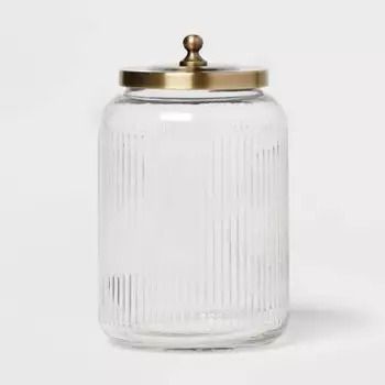 an empty glass jar with a gold lid